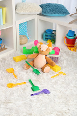 Colorful toys on fluffy carpet in children room