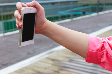 Woman hand holding mobile phone for taking photo