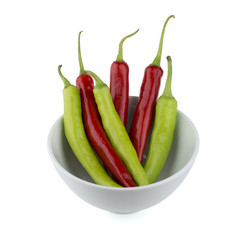 Red and green chili peppers in white bowl