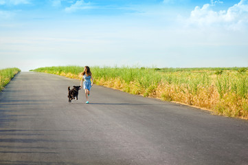 Obraz premium Girl with a dog for a walk