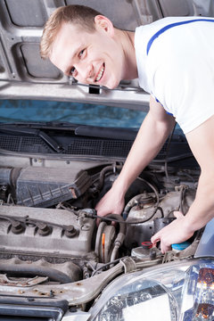 Mechanic checks a car engine