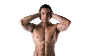 Muscular shirtless young man covering ears with hands