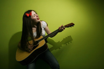 Fototapeta premium Brunette wildly playing guitar