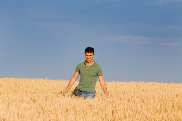 Naklejka na ściany i meble Smiling worker in barley field