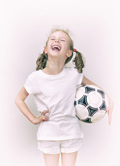 Little girl with ball having fun.