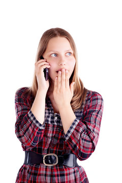 Surprised teen girl talking on the mobile phone