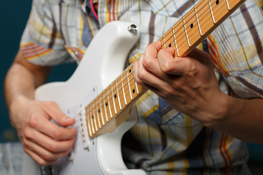 play on guitar, selective focus on part of strings