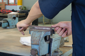 man sharpening steel by rasp