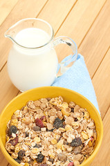 Plate with raw oatmeal on wooden table.