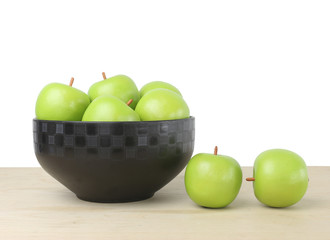 green apple on wood table and a white background