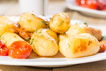 Roasted potatoes with carrot and tomatoes