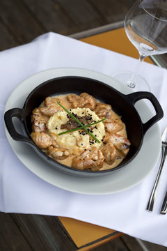 Sweetbreads with sauce in a dish, pollenta and morels