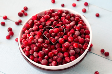 Frozen Cranberries in Bowl within heart shaped cookie cutter