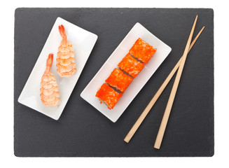 Sushi maki and shrimp sushi on black stone