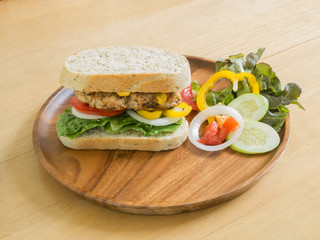 Homemade Club Sandwich with pork and vegetable on the wood tray