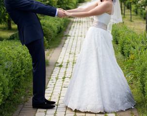 Bride and groom sitting in a city park