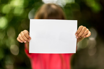 Girl with blank piece of paper