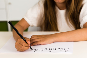 Girl writing the ABC alphabet