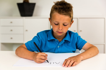 Boy writing the ABC alphabet