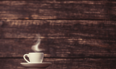 Tea or coffee cup on wooden table.