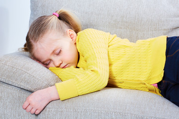 Little girl sleep on sofa in casual