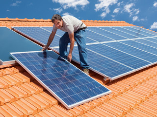 installing alternative energy photovoltaic solar panels - 66273326