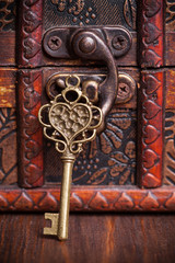 vintage key and old treasure chest on wooden table