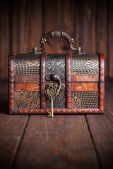 vintage key and old treasure chest on wooden table