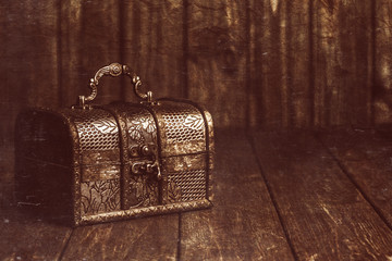 closed treasure chest standing on wooden table