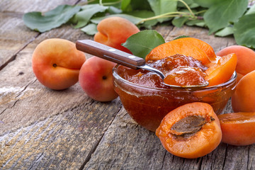 Healthy domestic apricot jam on old rustic table