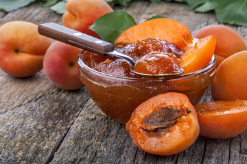 Healthy domestic apricot jam on old rustic table