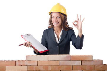 Woman with notepad on brick wall