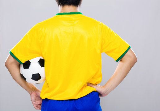 Back view of sport man hold football