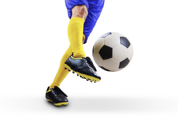 Obraz na płótnie Canvas Football player kicking the ball
