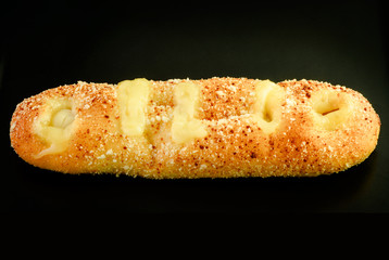 sauce salad above fresh gold bread  on black background