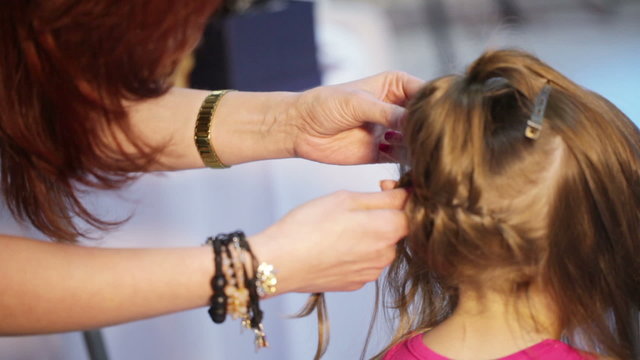 Weaving cornrows child