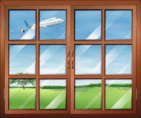 A window with a view of the airplane in the sky