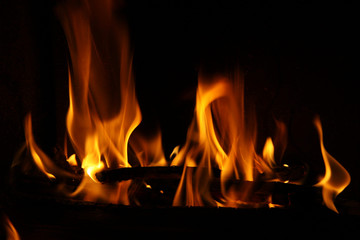 Fire in a fireplace, fire flames on a black background
