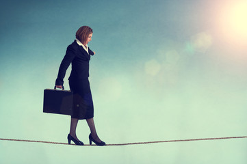 businesswoman on a tightrope