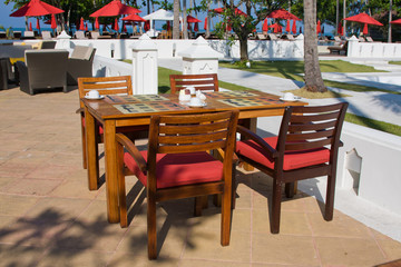 Table and chairs in empty cafe. Thailand.