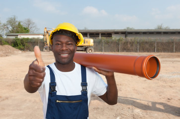 African construction worker with pipe showing thumb