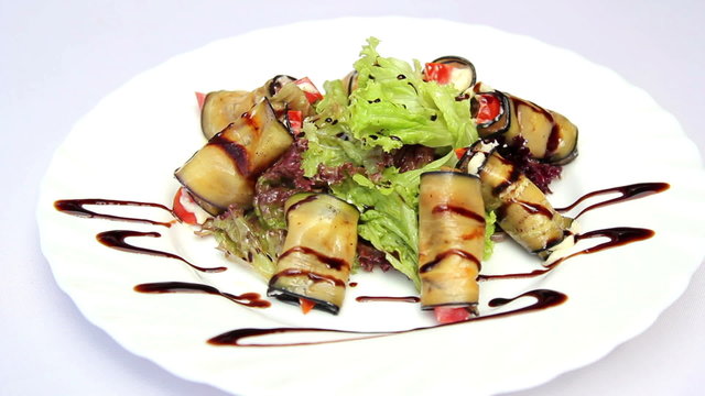 Dish of eggplant and tomato.Eggplant rolls with sauce.