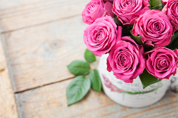 Fototapeta na wymiar Bouquet of beautiful pink roses on wooden background.