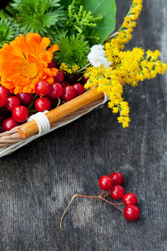 Bouquet of autumn flowers and berries in basket