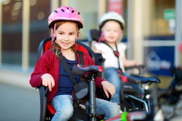 Obraz premium Two little sisters ready to ride a bike