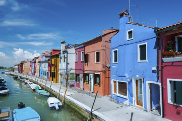 Fototapeta na wymiar Burano island canal, colorful houses and boats, Italy.