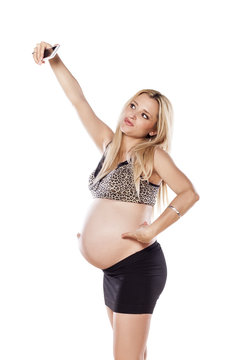 Pregnant women make a self-portrait with her mobile phone