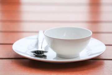 plate with spoon on wooden table