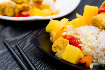 Chicken with pineapple and garnished with rice