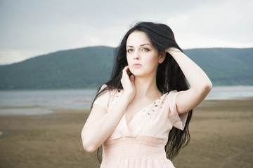 Portrait of a beautiful young woman in summer